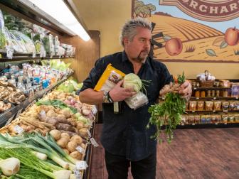 Guy grabs ingredients as seen on Guy's Grocery Games season 24.
